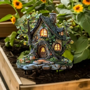 Solar powered tree house garden ornament with warm LED lights and fairy tale resin design