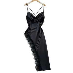 Black satin slip dress with lace trim and asymmetrical hem on white background