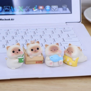 Four cute resin cat figurines displayed on a laptop keyboard for desk and car decoration