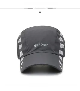 Detail of dark gray quick-dry sports cap with white mesh panels and sports logo print