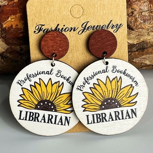Librarian sunflower wooden earrings with Professional Bookworm text on wood grain backdrop