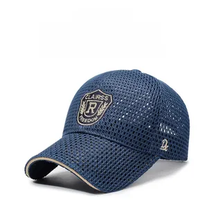 Detailed close-up of blue mesh baseball cap with embroidered shield patch and breathable fabric