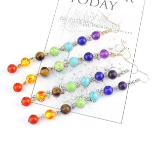 Bohemian rainbow gemstone bead tassel earrings with chakra stones on white background