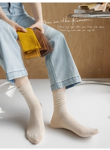 Detail of ribbed knit cotton blend mid-calf socks in warm autumn tones and colors