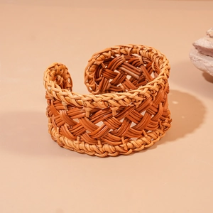 Handwoven rattan open cuff bracelet with geometric mesh design in natural brown finish
