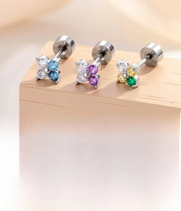 Detailed view of silver flower studs with colorful zircons and titanium steel rod