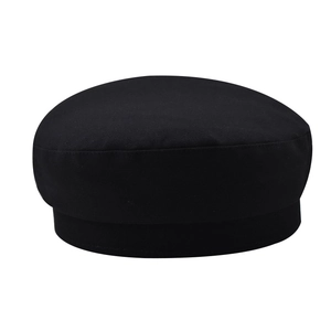Detailed top view of a classic black cotton newsboy cap featuring fine woven texture