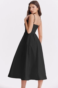 Detail of a black backless maxi dress with thin straps and elegant waistline drape