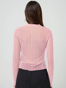 Detail view of pink sheer long sleeve top showing ribbed texture and back fit on a model