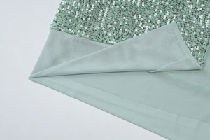 Close-up of mint green sequins and mesh fabric detail on the slim-fit formal maxi dress