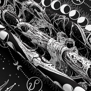Macro detail of Bohemian tapestry showing celestial skull and astrology moon phase patterns