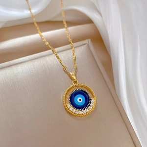 Luxury gold titanium necklace featuring a blue evil eye pendant with sparkling zircons