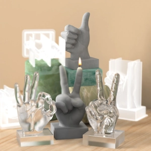DIY silicone molds for hand gesture candles and resin trophies showing OK and V shapes