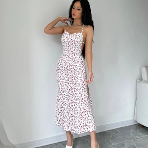 Detailed view of the backless floral midi dress with a side slit and halter neck design