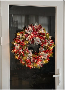 Detail of 50cm Christmas wreath with red berries, buffalo plaid bow and warm LED lights