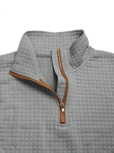 Close-up of grey quilted sweatshirt featuring half-zip collar and brown piping detail