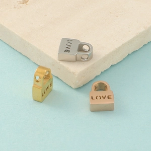 Detailed view of hollow Love lock stainless steel beads in silver, gold and rose gold