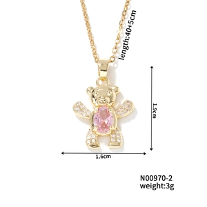 Detailed view of gold bear pendant with pink gemstone and rhinestone inlay size dimensions