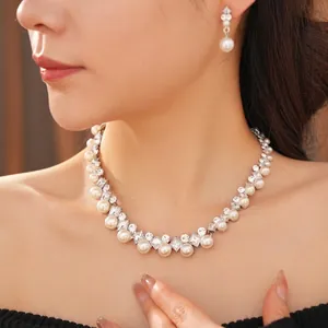 Elegant pearl necklace and earring set with zircon diamonds shown on a model for a classy look