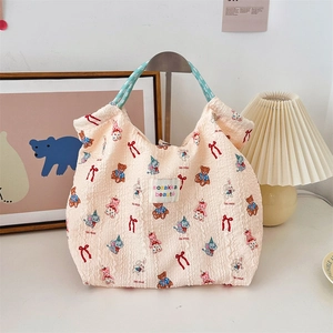 Close-up of embossed bubble texture fabric and cute cartoon animals on a cream tote bag