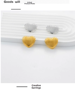 Detail showing the ribbed metal texture and 18K gold plating on heart-shaped earrings