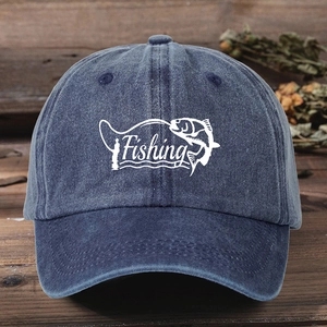 Adjustable dark blue washed denim baseball cap with white Fishing embroidery on a wooden table