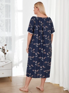 Detail of plus size navy paisley sleepwear featuring white lace trim on short sleeves