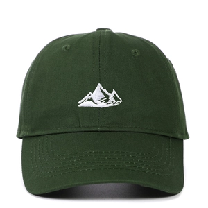 Detailed close-up of white mountain embroidery on dark green cotton baseball cap