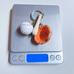 Detailed view of baseball keychain weighing 11.4g on a digital scale for accuracy
