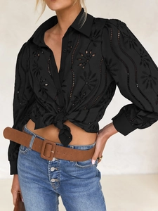 Close-up of black hollow embroidery floral pattern on casual bubble sleeve cardigan
