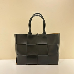 Handmade black woven leather tote bag with top handles and brown lining for summer