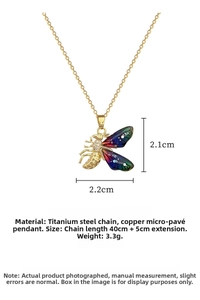 Macro detail of bee pendant with colorful iridescent wings and micro-pave crystals