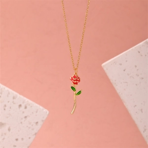 Elegant 3D red rose pendant necklace with gold chain on pink background main view