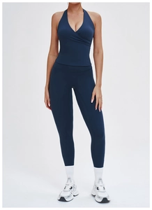 Detail of dark blue yoga set with crossover halter top and high waist leggings