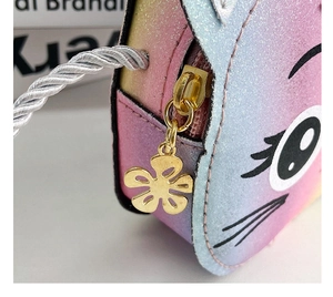 Detail of glitter rainbow kids bag featuring golden flower zipper and cat eyes pattern