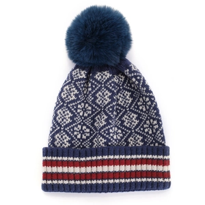 Deep blue bohemian knit beanie with geometric diamond pattern and faux fur pompom