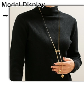 Detail of 18K gold-plated Y-necklace with sliding adjuster and polished ball pendants