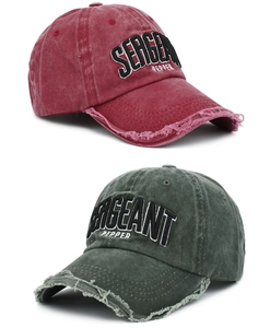 Macro detail of 3D letter embroidery and distressed brim on vintage washed cotton baseball caps