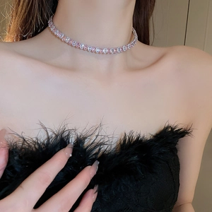 Sparkling pink and white zircon oval collar necklace worn by model on black feather top