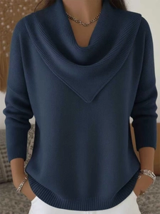 Close-up of a navy blue cowl neck sweater featuring soft knit fabric and ribbed hem details