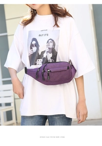 Deep purple waist bag worn on waist with adjustable belt and multiple zipper pockets