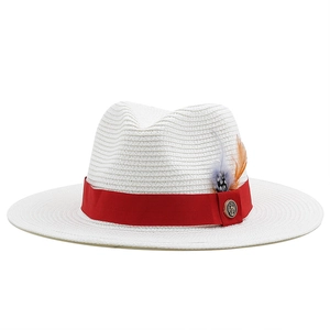White straw fedora hat with a red ribbon and feather accent for summer beach vacations