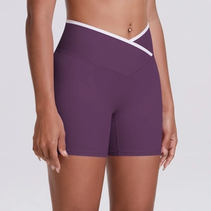 High-waisted purple yoga shorts with crossover V-waist design and white trim detailing
