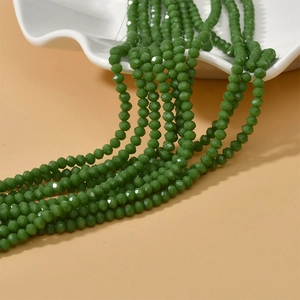 Detailed view of faceted 4mm green glass wheel beads for DIY jewelry making