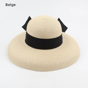 Detailed top view of a beige straw hat with a wide brim and elegant black ribbon bow