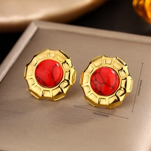 Detail view of 1.9cm vintage gold earrings with red stone and textured gear edge