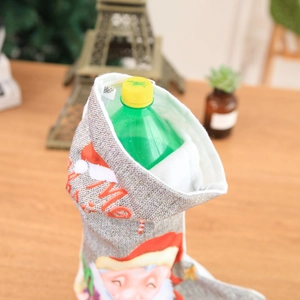 Detailed view of grey knitted Christmas stocking with Santa motif and interior capacity demo