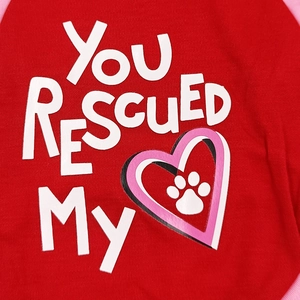 Close-up of red cotton dog vest with You Rescued My text and pink heart paw print