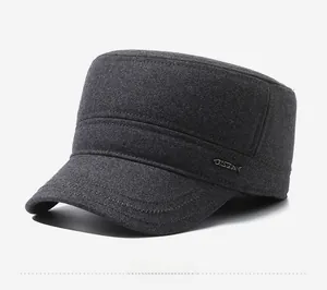 Detail view of the gray wool cadet cap showing the metal logo and reinforced stitching
