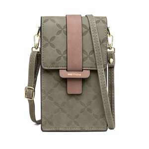 Close-up of green PU leather phone bag with geometric embossing and pink buckle strap